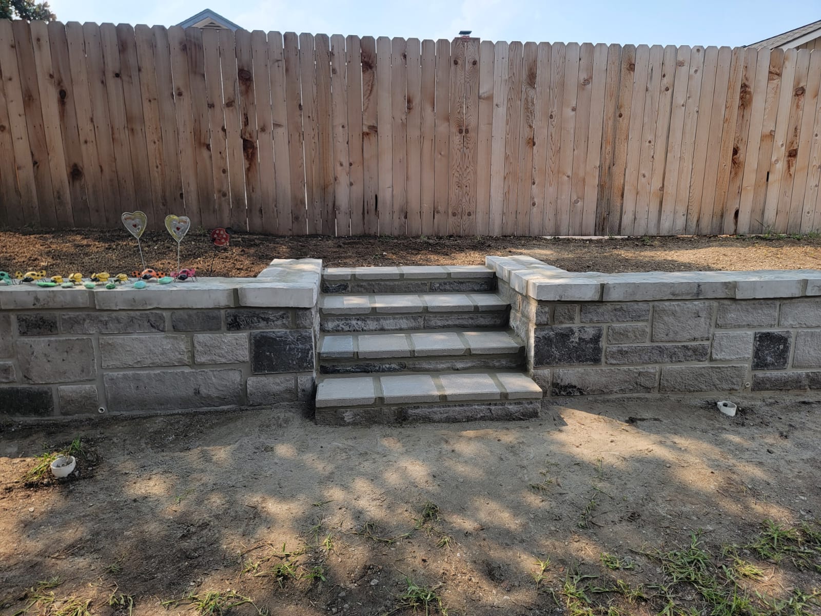 Retaining wall with centered steps leading to an upper yard